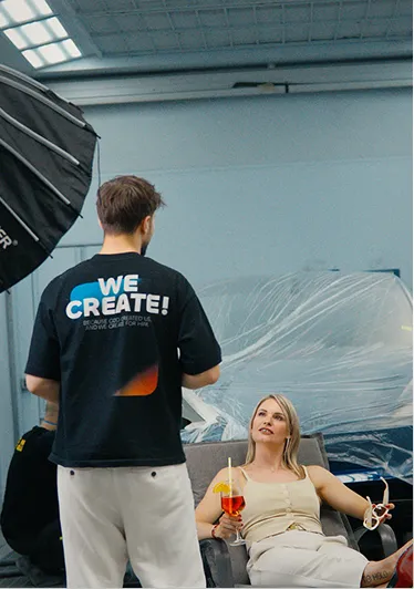 Teammitglied im C-Pictures-Shirt «We create!» beim Dreh mit einer Darstellerin